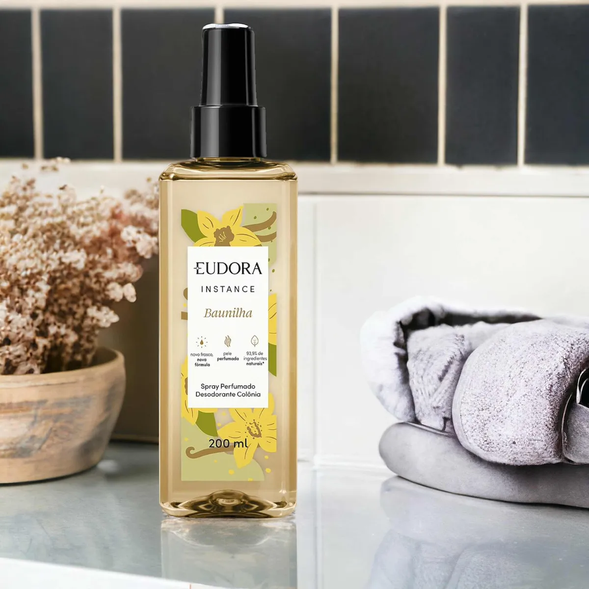 Frasco dourado do body splash Eudora Instance Baunilha em fundo elegante.